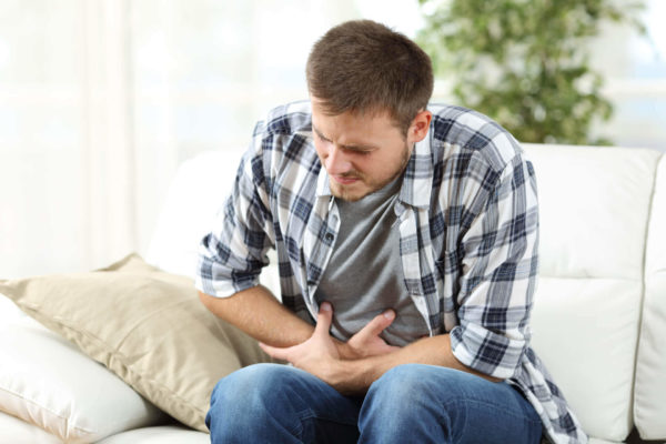 Man In Living Room Has Stomach Pain From Gastritis
